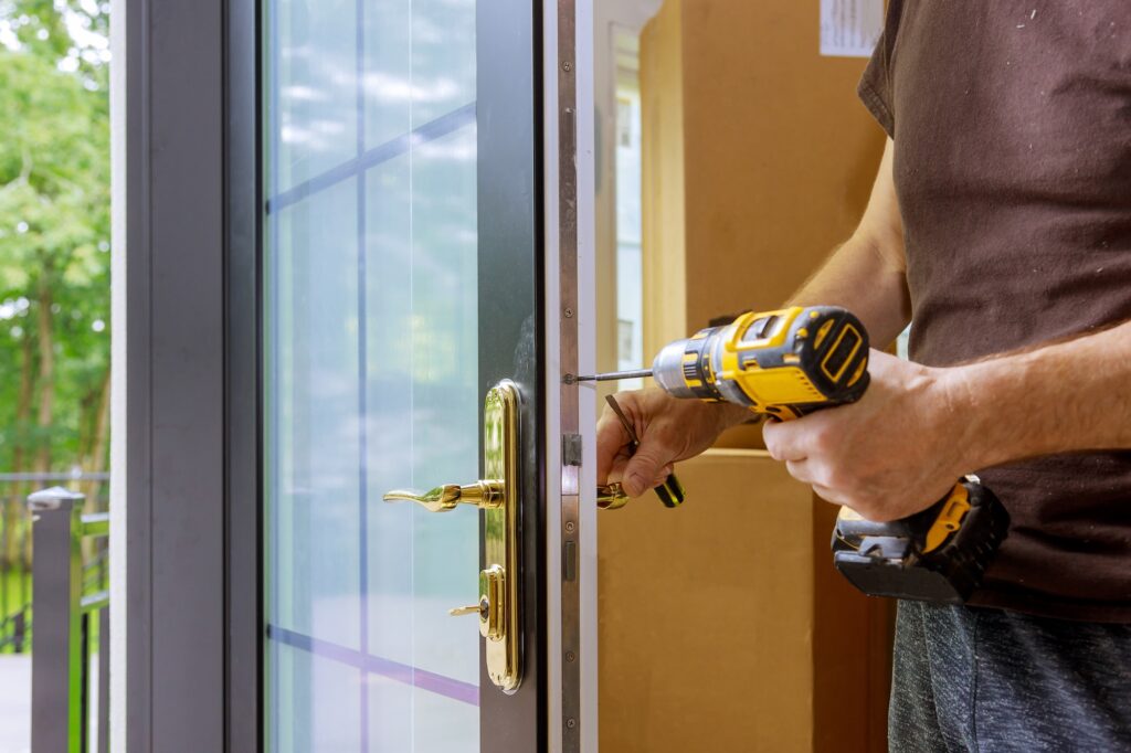 Closeup of man installing handle on exterior door