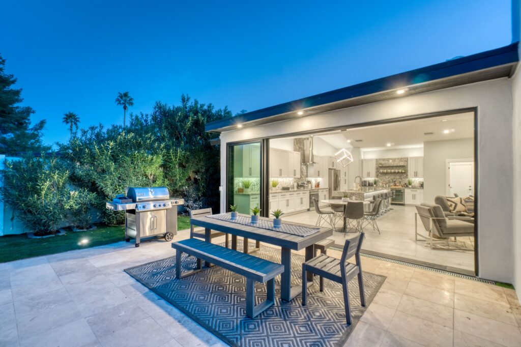 A Florida patio with sliding glass doors connecting it to the house