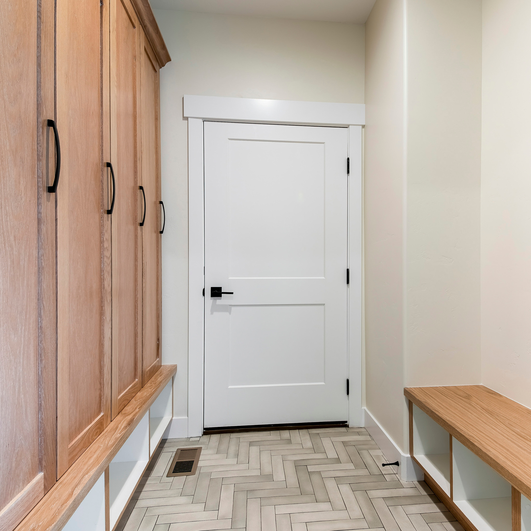 Fire-Rated Interior Doors & Safety Codes in Florida: What Homeowners Should Know 1 White fire-rated interior door with black hardware between a garage mudroom and the main living space.